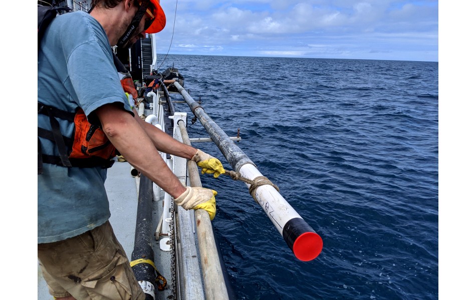 A sediment core being brought up alongside a ship. A sediment core being brought up alongside a ship.