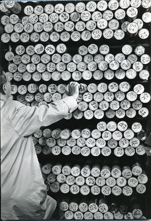 A technician looking at a rack of core tubes
