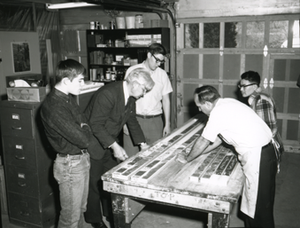 Doc Ewing and students examine cores around a table